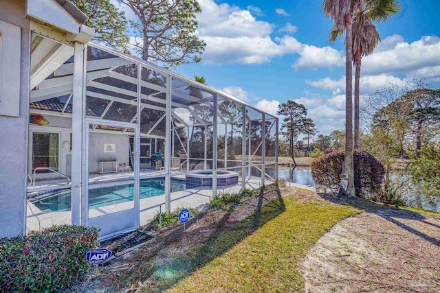 view of swimming pool with glass enclosure, a water view, and a patio