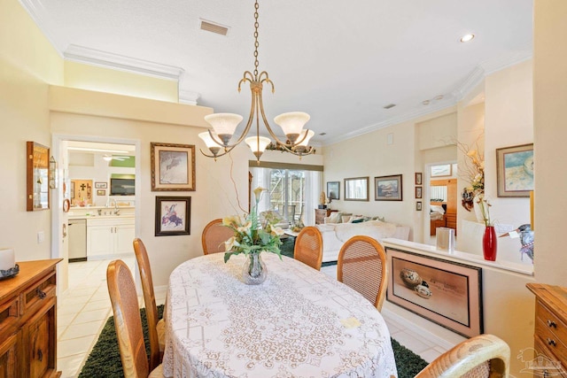 tiled dining space with sink, ceiling fan with notable chandelier, and ornamental molding