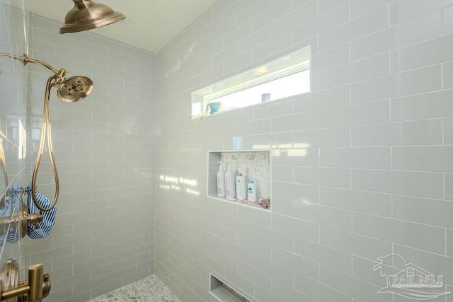 full bathroom with tiled shower