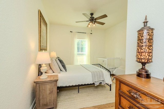 bedroom featuring light wood-type flooring and ceiling fan