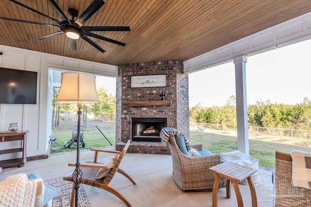 living room with an outdoor brick fireplace, concrete floors, wood ceiling, and a ceiling fan