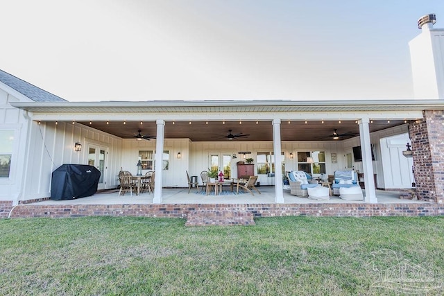 back of house featuring a lawn, an outdoor hangout area, a patio, and french doors