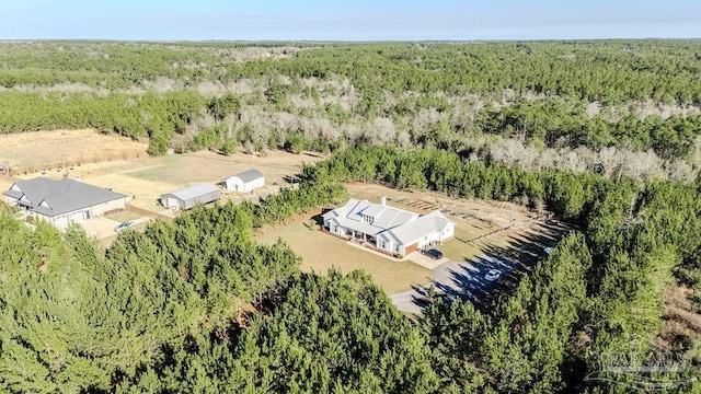 drone / aerial view featuring a rural view and a view of trees