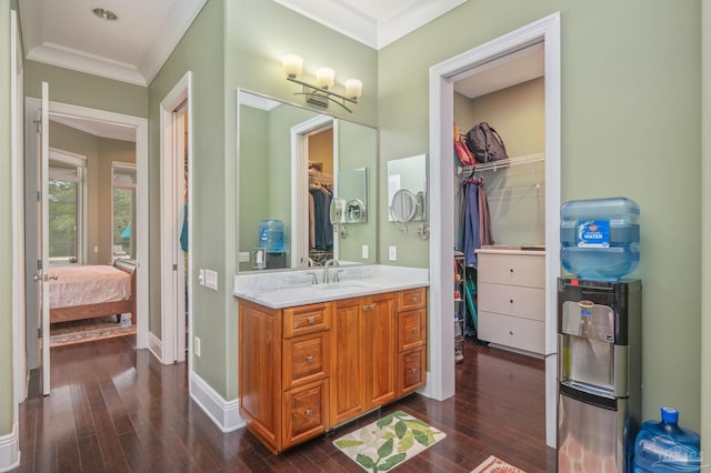 337 Grande Oaks Blvd, Cantonment, FL 32533 - ensuite bathroom with vanity, wood finished floors, ornamental molding, a spacious closet, and baseboards