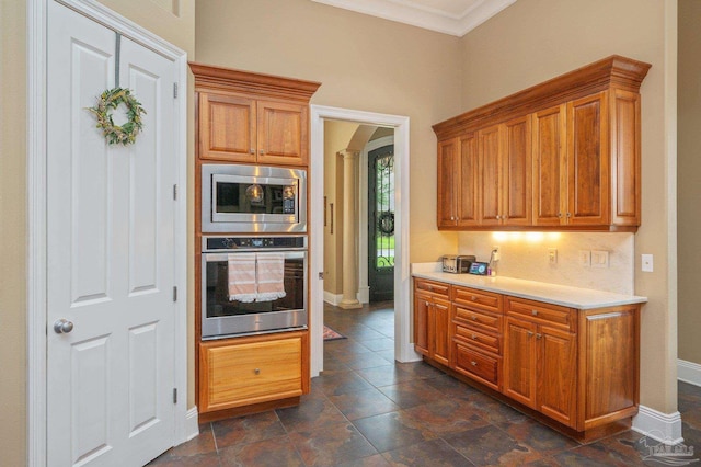 337 Grande Oaks Blvd, Cantonment, FL 32533 - kitchen with appliances with stainless steel finishes, arched walkways, light countertops, ornamental molding, and baseboards