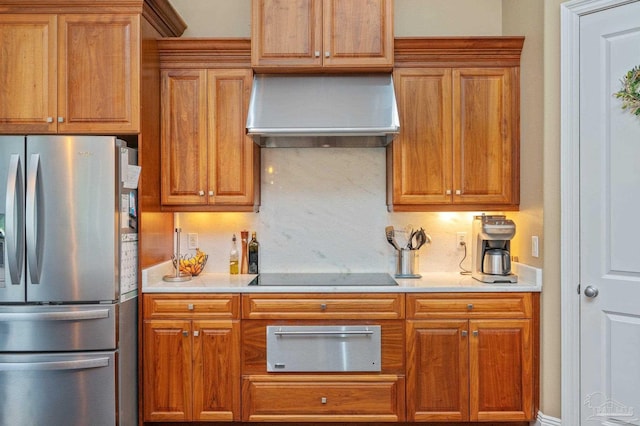 337 Grande Oaks Blvd, Cantonment, FL 32533 - kitchen featuring freestanding refrigerator, wall chimney range hood, a warming drawer, black electric stovetop, and light countertops