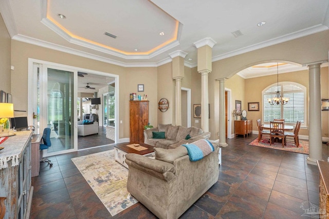 337 Grande Oaks Blvd, Cantonment, FL 32533 - living room featuring ornate columns, arched walkways, a chandelier, ornamental molding, and a raised ceiling