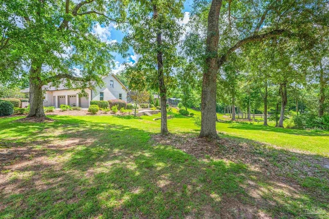 337 Grande Oaks Blvd, Cantonment, FL 32533 - view of green lawn featuring a garage