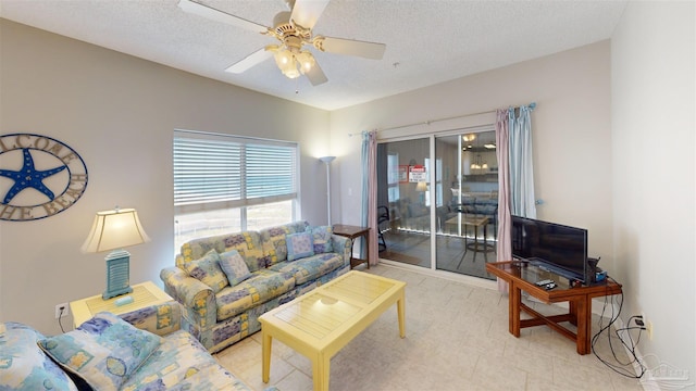 living room featuring a textured ceiling and ceiling fan