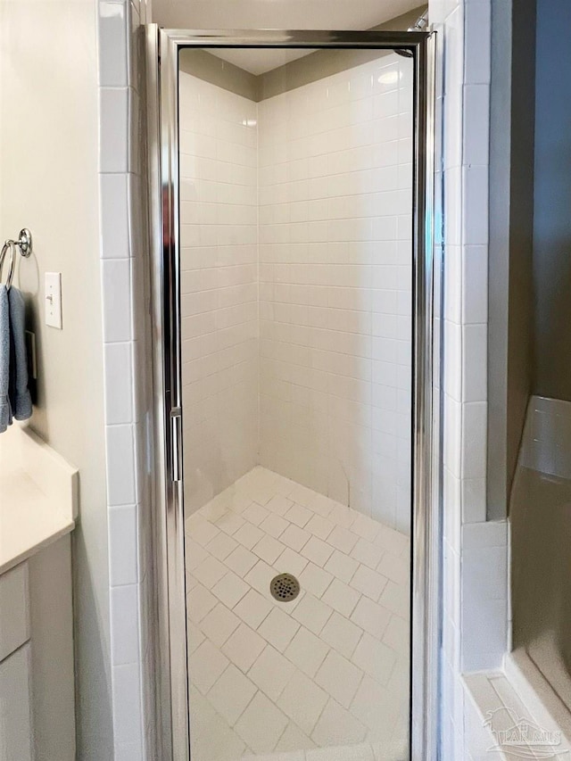 bathroom with vanity and a shower with shower door