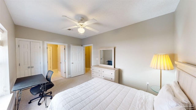 carpeted bedroom with a closet, ceiling fan, and a textured ceiling