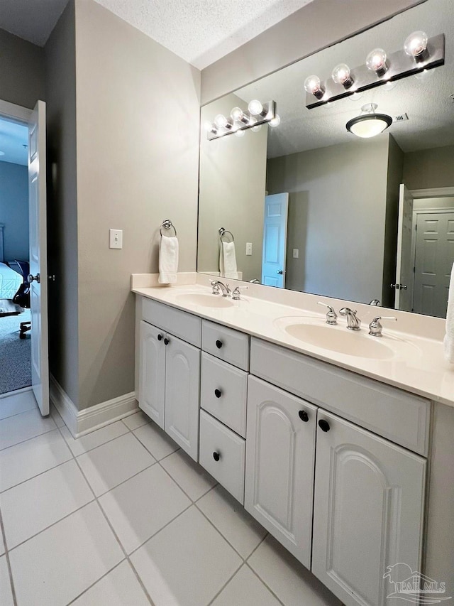 bathroom featuring vanity, a textured ceiling, and tile patterned floors