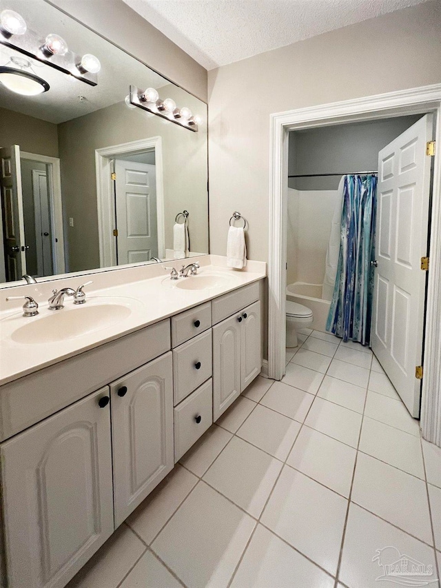 full bathroom featuring toilet, shower / bath combo, vanity, and tile patterned floors