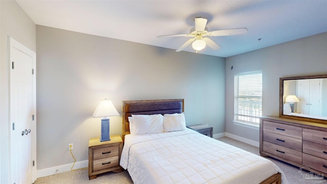 bedroom with light colored carpet and ceiling fan