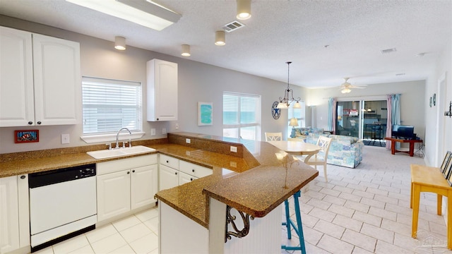 kitchen featuring a breakfast bar, dishwasher, white cabinets, and sink