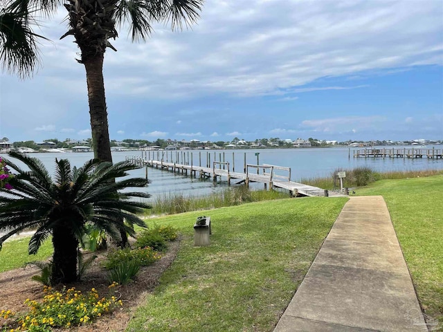 view of dock featuring a yard and a water view