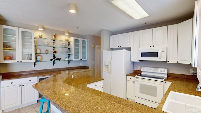 kitchen with sink, white cabinetry, white appliances, and dark stone countertops