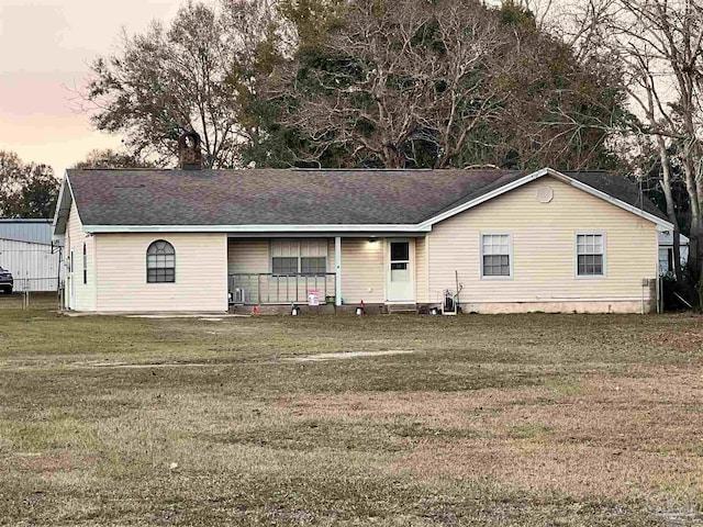 ranch-style home with a lawn