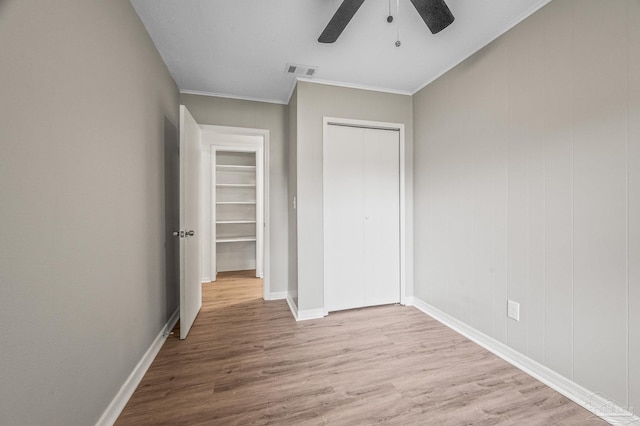 4905 State St, Pensacola, FL 32506 - unfurnished bedroom featuring wood finished floors, a closet, crown molding, baseboards, and ceiling fan