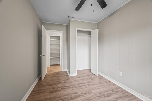 4905 State St, Pensacola, FL 32506 - unfurnished bedroom with wood finished floors, a closet, ornamental molding, ceiling fan, and baseboards