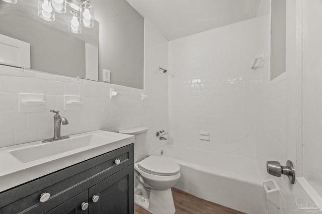 4905 State St, Pensacola, FL 32506 - full bathroom with wood finished floors, toilet, shower / washtub combination, vanity, and tile walls