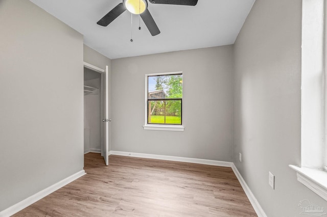 4905 State St, Pensacola, FL 32506 - unfurnished bedroom with light wood-style flooring, baseboards, a closet, and a ceiling fan
