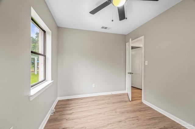 4905 State St, Pensacola, FL 32506 - empty room with healthy amount of natural light, light wood-type flooring, ceiling fan, and baseboards