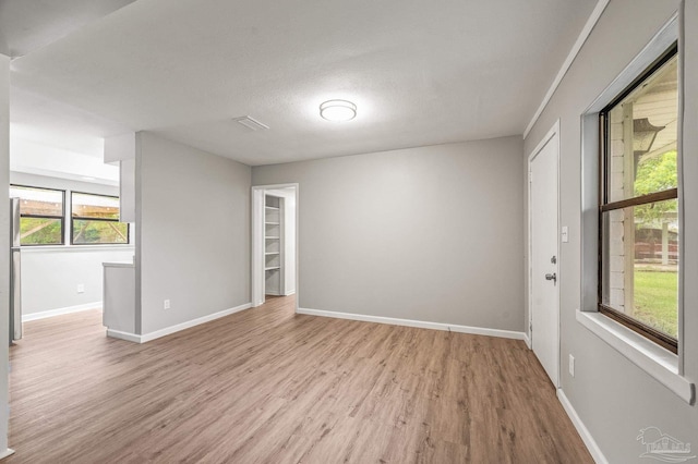 4905 State St, Pensacola, FL 32506 - spare room featuring light wood finished floors and baseboards