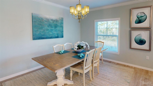 dining space with a chandelier, light hardwood / wood-style floors, and ornamental molding