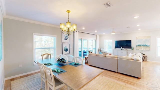 dining room featuring light wood-type flooring, ceiling fan with notable chandelier, and ornamental molding