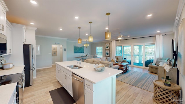 kitchen with white cabinetry, an island with sink, hanging light fixtures, and stainless steel appliances