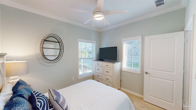 carpeted bedroom featuring ceiling fan and crown molding