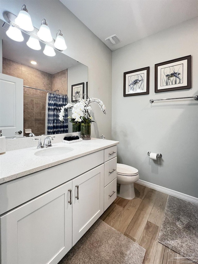 bathroom featuring vanity, curtained shower, toilet, and wood-type flooring