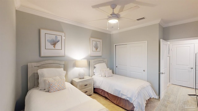 bedroom with a closet, ornamental molding, and ceiling fan