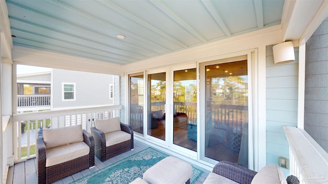 sunroom with beam ceiling and a wealth of natural light