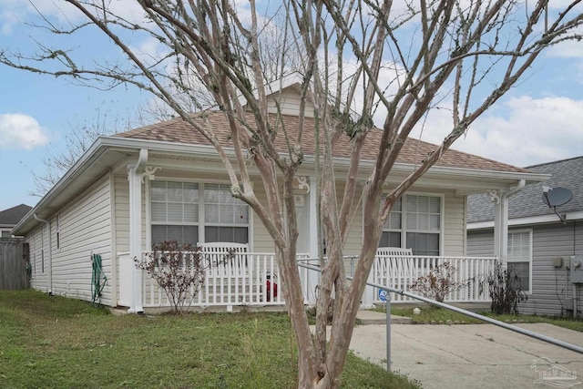 view of front of home with a porch and a front lawn