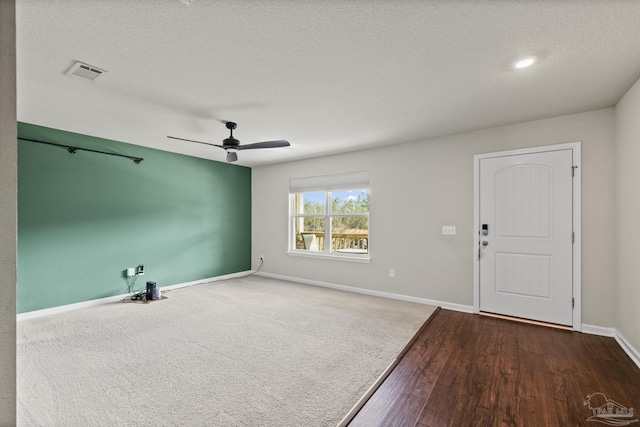 interior space with ceiling fan and a textured ceiling