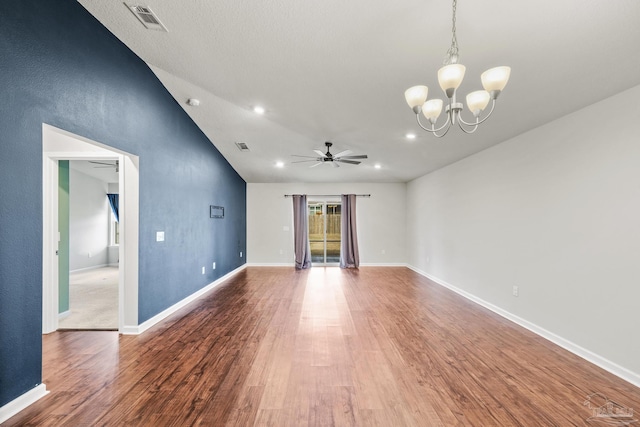 unfurnished living room featuring vaulted ceiling, wood-type flooring, and ceiling fan with notable chandelier