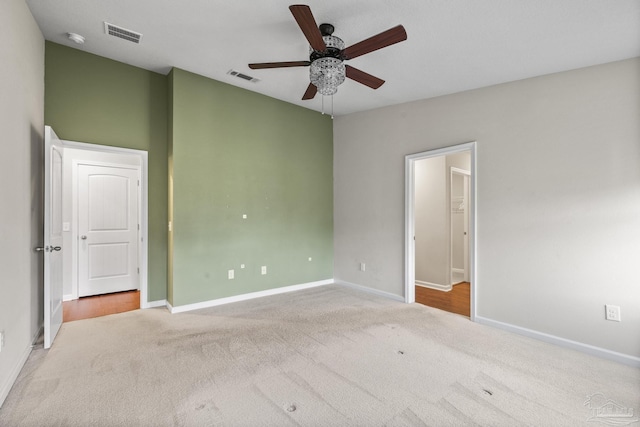 spare room featuring carpet, lofted ceiling, and ceiling fan