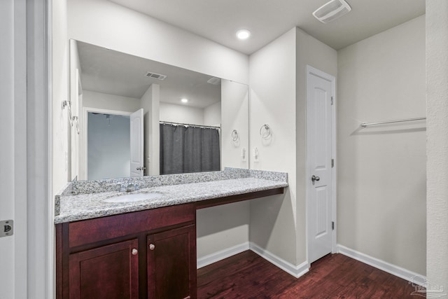 bathroom featuring hardwood / wood-style flooring, vanity, and a shower with shower curtain