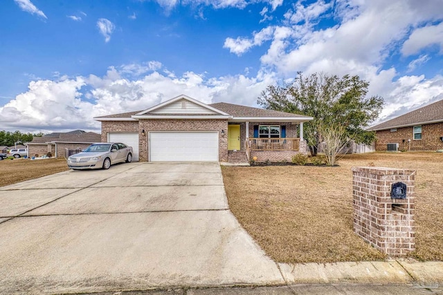 ranch-style home with a garage, a front yard, and covered porch