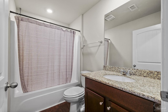 full bathroom with hardwood / wood-style floors, vanity, toilet, and shower / bath combo with shower curtain