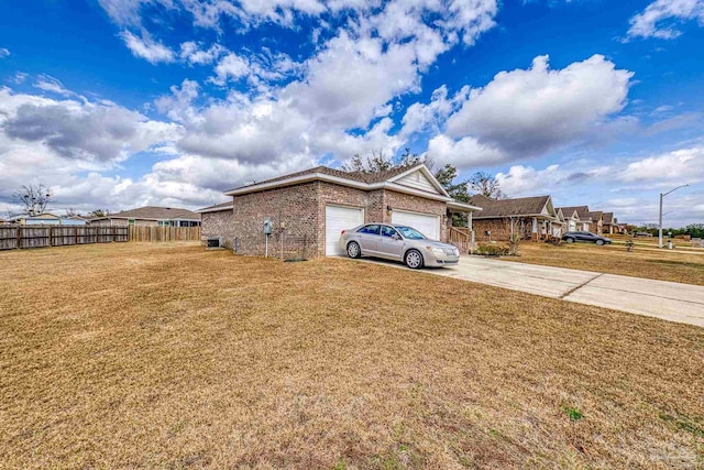 view of side of home featuring a garage and a lawn