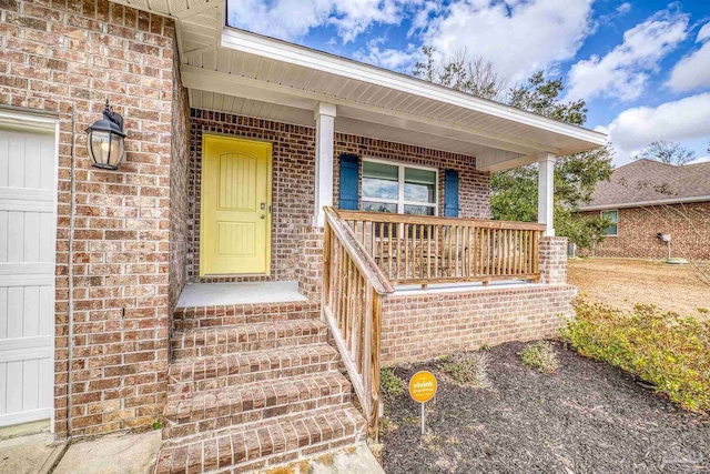 view of exterior entry with a porch