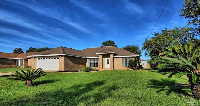 ranch-style house featuring a garage and a front lawn