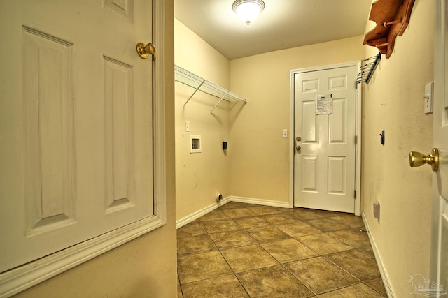 laundry room featuring laundry area, baseboards, hookup for a washing machine, hookup for an electric dryer, and dark tile patterned floors