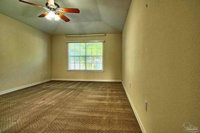 unfurnished room featuring vaulted ceiling, baseboards, dark colored carpet, and a ceiling fan