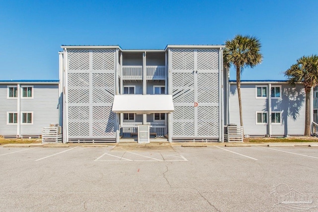 view of building exterior featuring uncovered parking