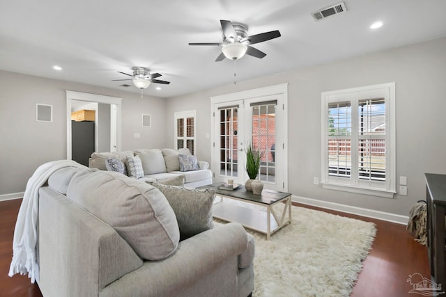 living room featuring ceiling fan, french doors, and dark hardwood / wood-style floors