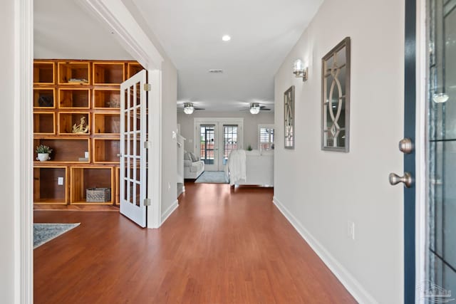 foyer entrance featuring french doors, dark hardwood / wood-style floors, and ceiling fan